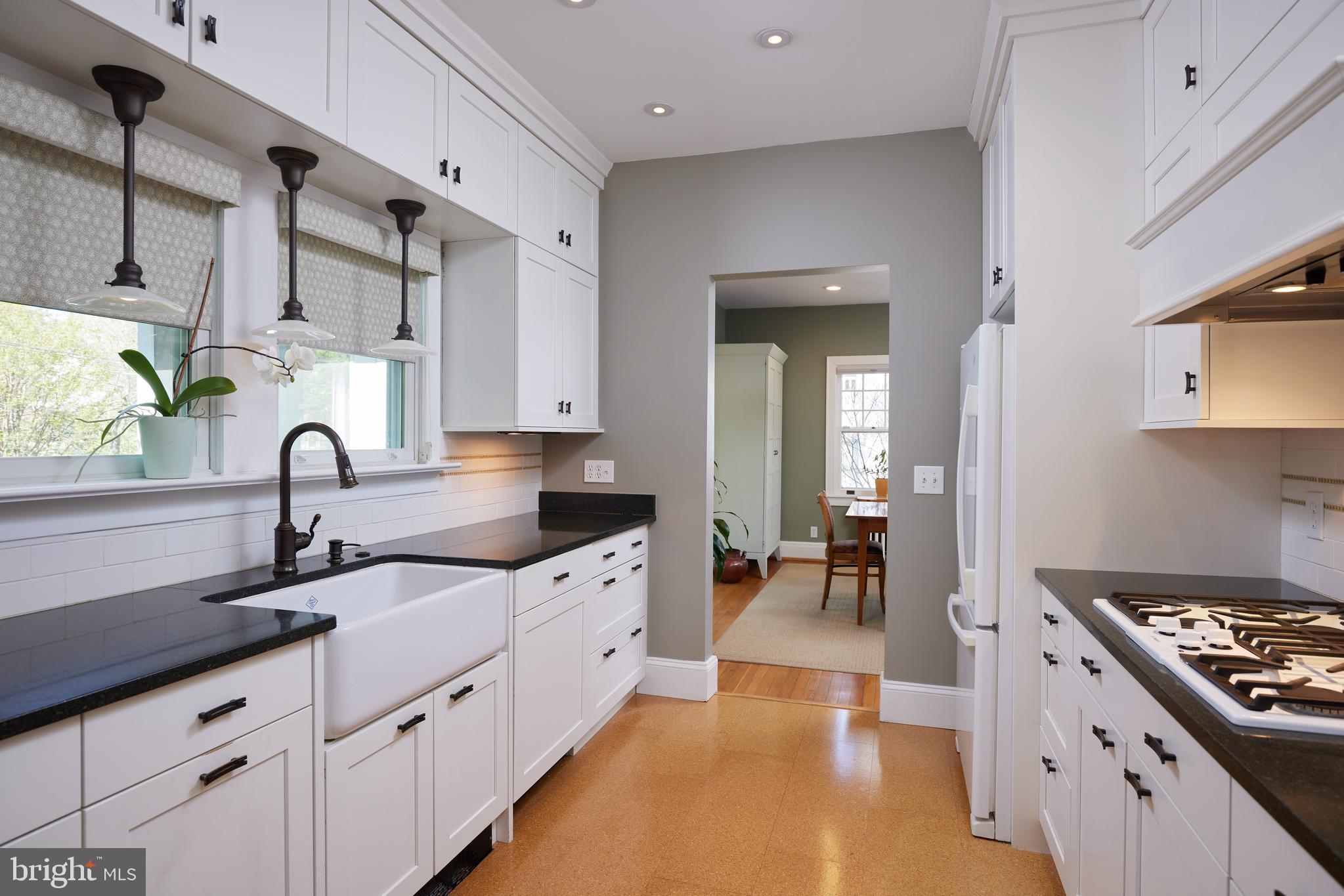 4236 River Road Northwest Washington, DC 20016 - Photo 21 of 44 a kitchen with granite countertop a sink stainless steel appliances and cabinets
