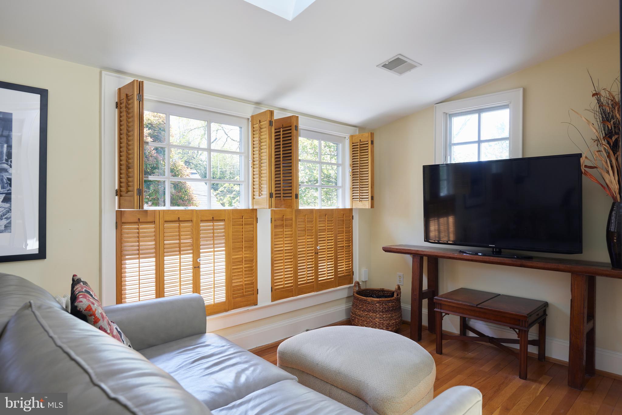 4236 River Road Northwest Washington, DC 20016 - Photo 36 of 44 a living room with furniture and a flat screen tv