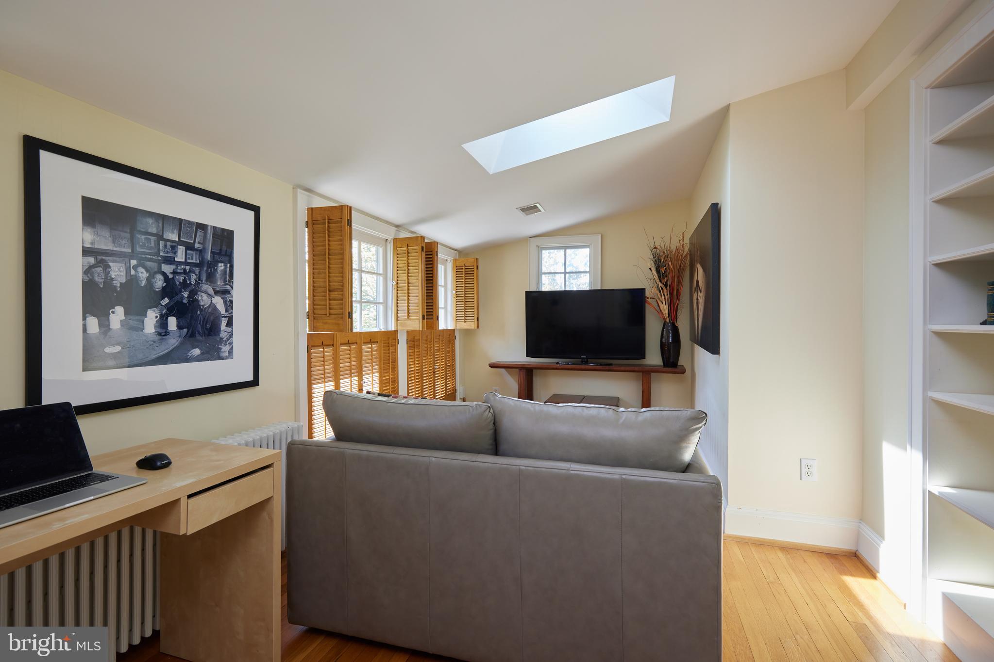 4236 River Road Northwest Washington, DC 20016 - Photo 38 of 44 a living room with furniture and a flat screen tv