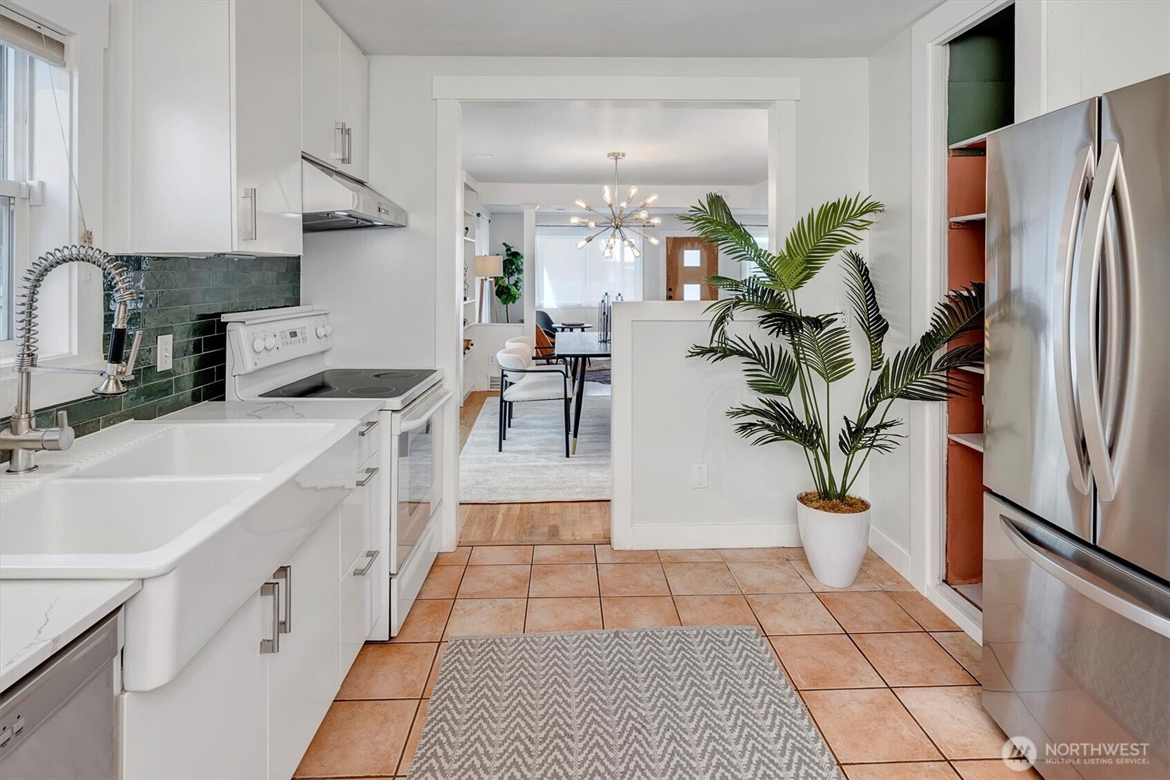 1112 North 80th Street Seattle, WA 98103 - Photo 13 of 29 a living room with stainless steel appliances kitchen island granite countertop a refrigerator a stove a sink and white cabinets