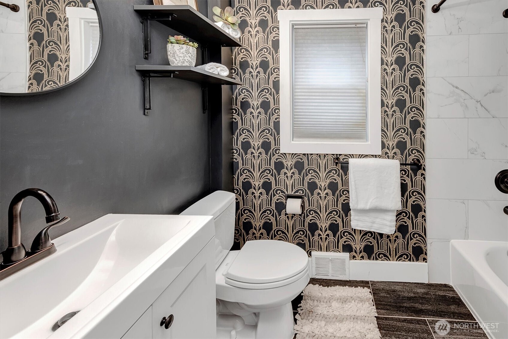 1112 North 80th Street Seattle, WA 98103 - Photo 15 of 29 a bathroom with a toilet and a sink