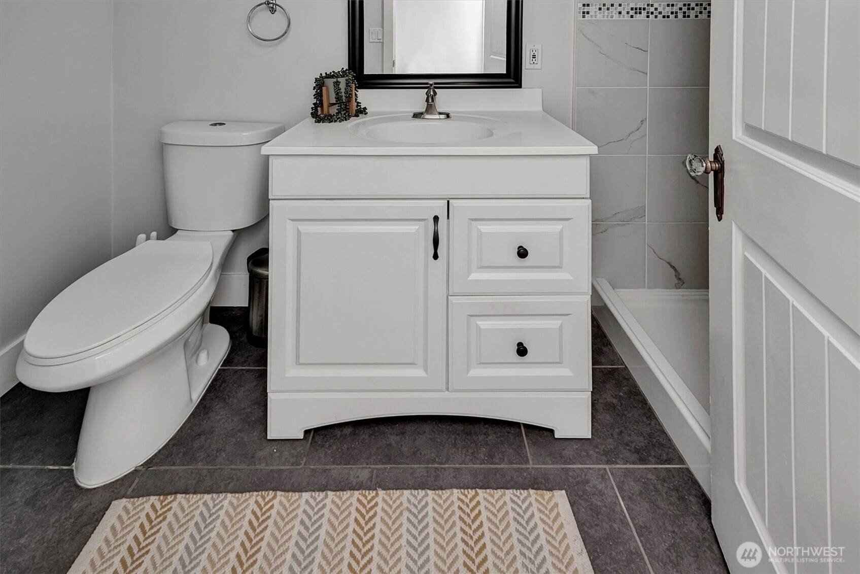 1112 North 80th Street Seattle, WA 98103 - Photo 21 of 29 a bathroom with a sink toilet and tub