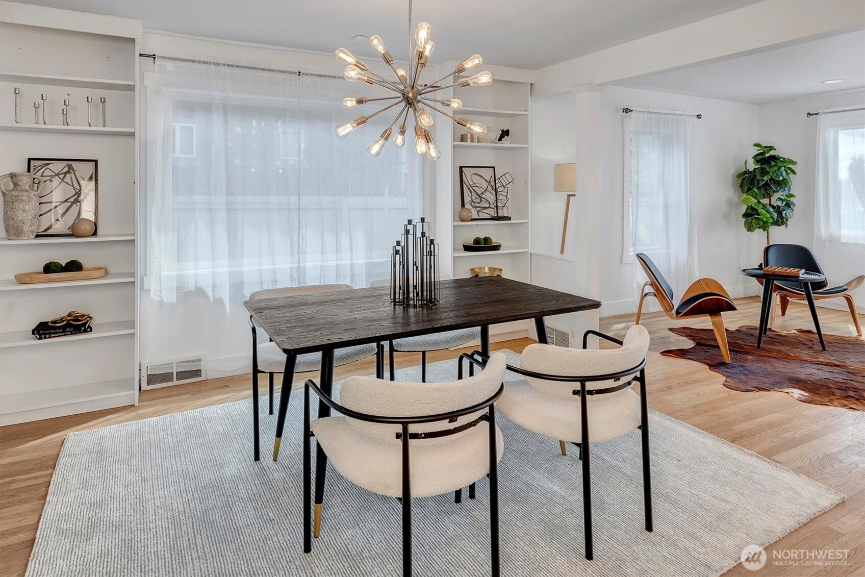 1112 North 80th Street Seattle, WA 98103 - Photo 6 of 29 a view of a dining room with furniture and chandelier