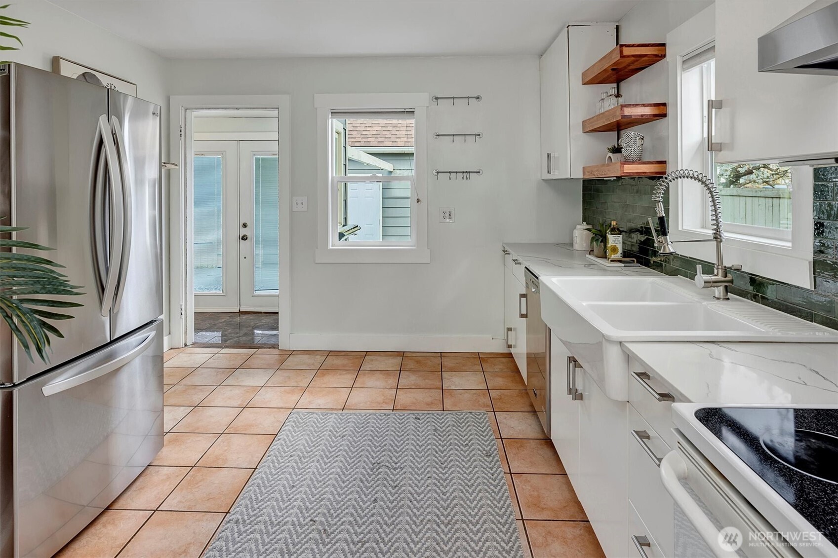 1112 North 80th Street Seattle, WA 98103 - Photo 10 of 29 a kitchen with stainless steel appliances a sink stove and refrigerator