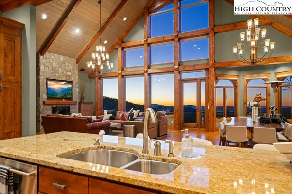 a kitchen with a sink and living room view