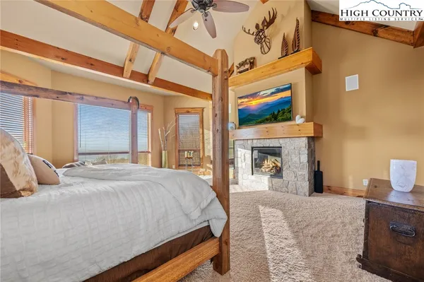 a bedroom with a bed and a fireplace