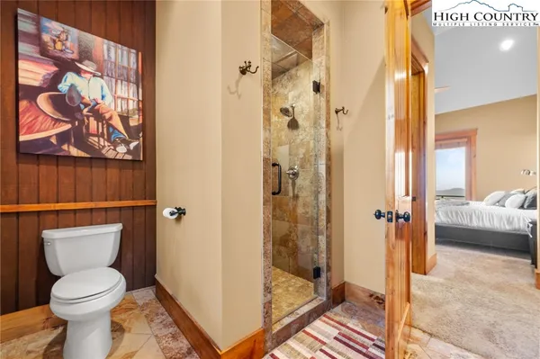 a bathroom with a toilet and a shower