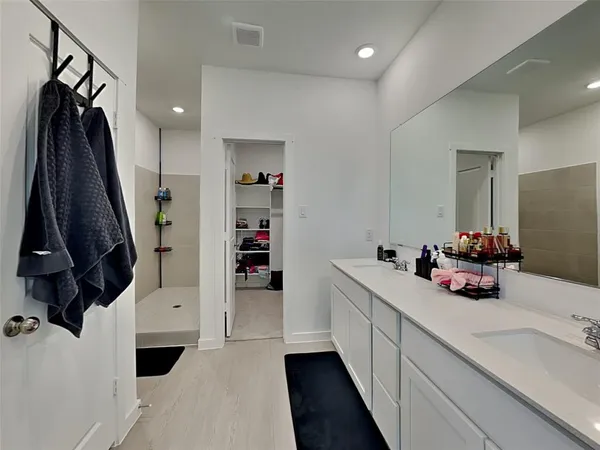 a view of walk in closet with clothes and shoes