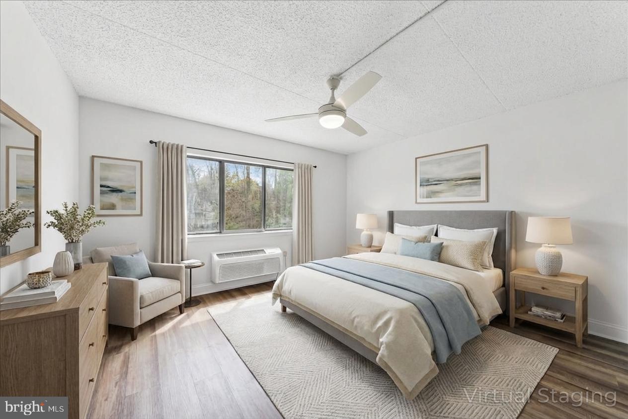 800 Avondale Road, Unit 5Q Wallingford, PA 19086 - Photo 12 of 25 a bedroom with a large bed and a couch