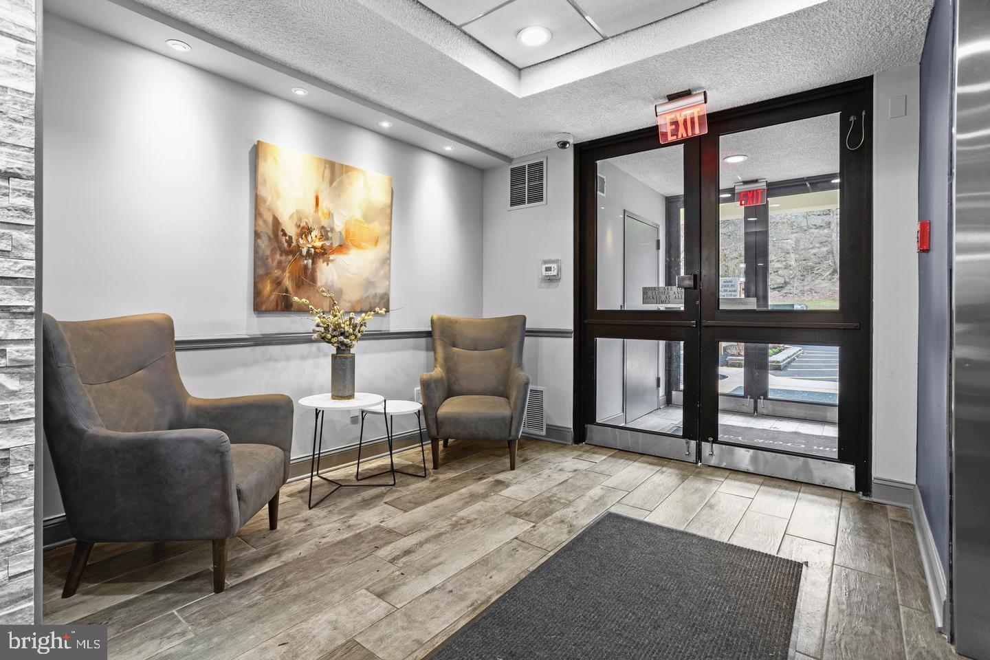 800 Avondale Road, Unit 5Q Wallingford, PA 19086 - Photo 23 of 25 a living room with furniture and large windows