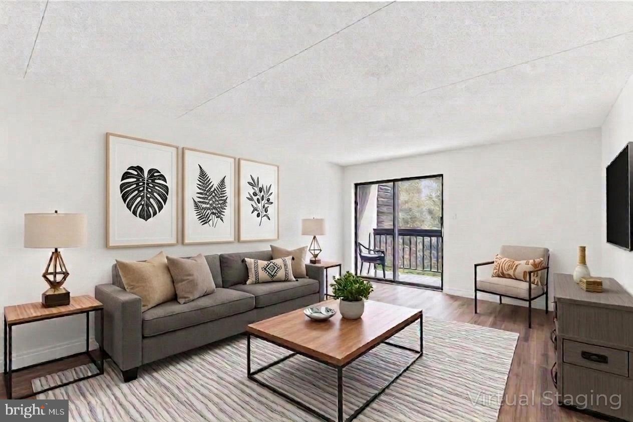 800 Avondale Road, Unit 5Q Wallingford, PA 19086 - Photo 4 of 25 a living room with furniture and wooden floor