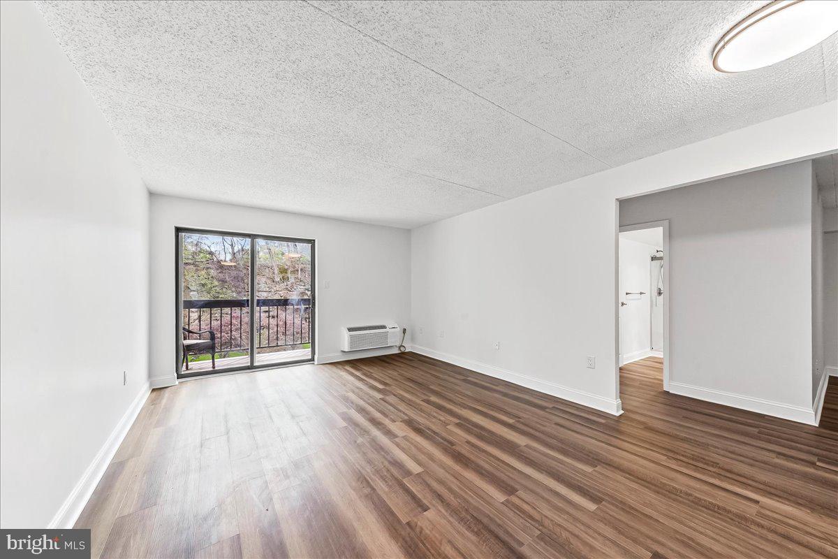 800 Avondale Road, Unit 5Q Wallingford, PA 19086 - Photo 6 of 25 an empty room with wooden floor and windows