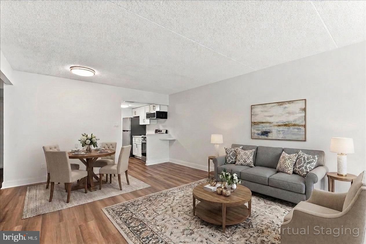 800 Avondale Road, Unit 5Q Wallingford, PA 19086 - Photo 7 of 25 a living room with furniture and a dining table with rug