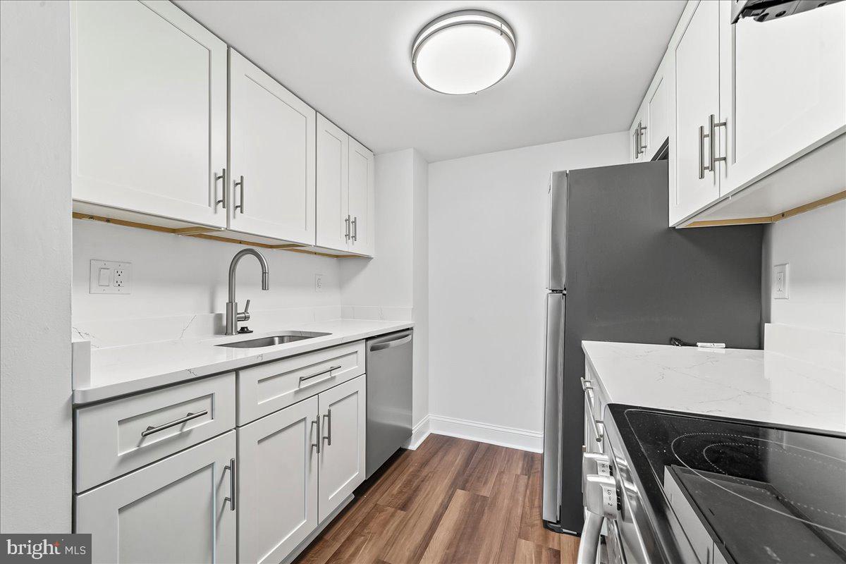 800 Avondale Road, Unit 5Q Wallingford, PA 19086 - Photo 10 of 25 a kitchen with a sink dishwasher and wooden cabinets