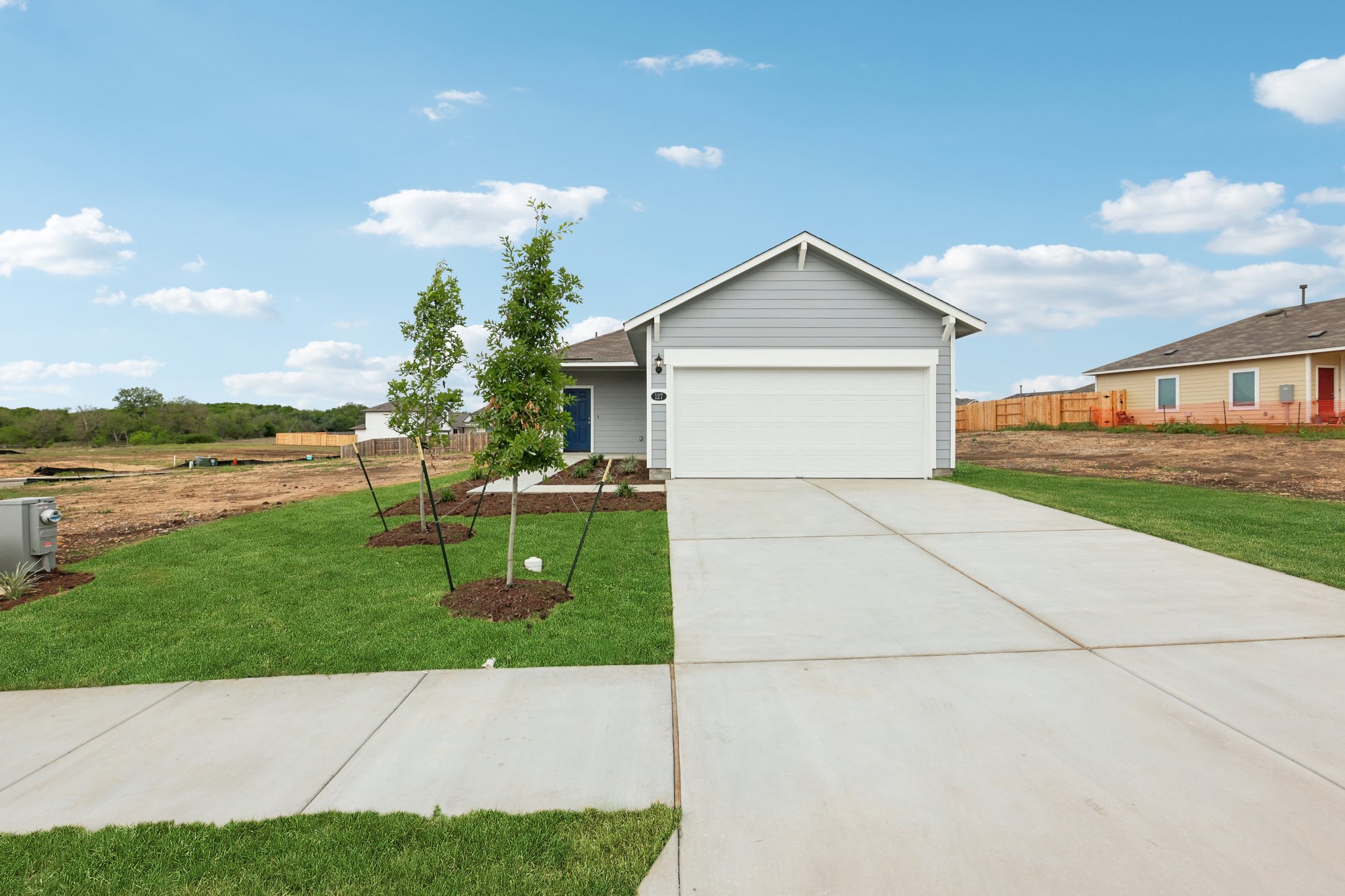 a view of a house with a yard and a garden