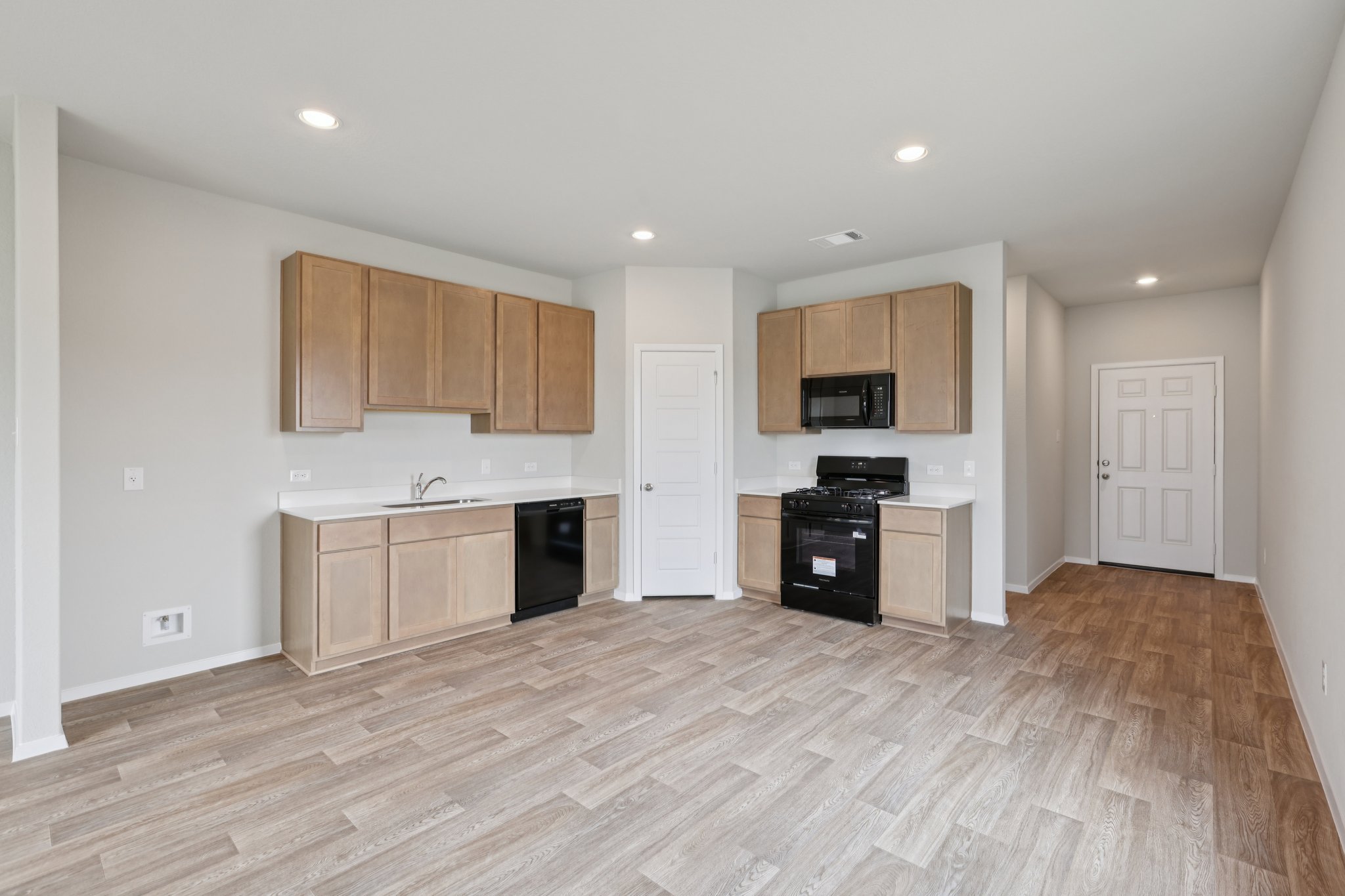 127 Tempest Trail Maxwell, TX 78656 - Photo 4 of 29 a large kitchen with stainless steel appliances granite countertop a stove and a refrigerator