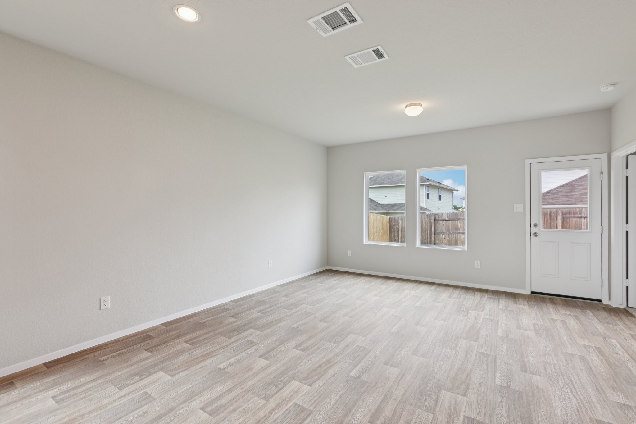 127 Tempest Trail Maxwell, TX 78656 - Photo 8 of 29 an empty room with wooden floor and windows