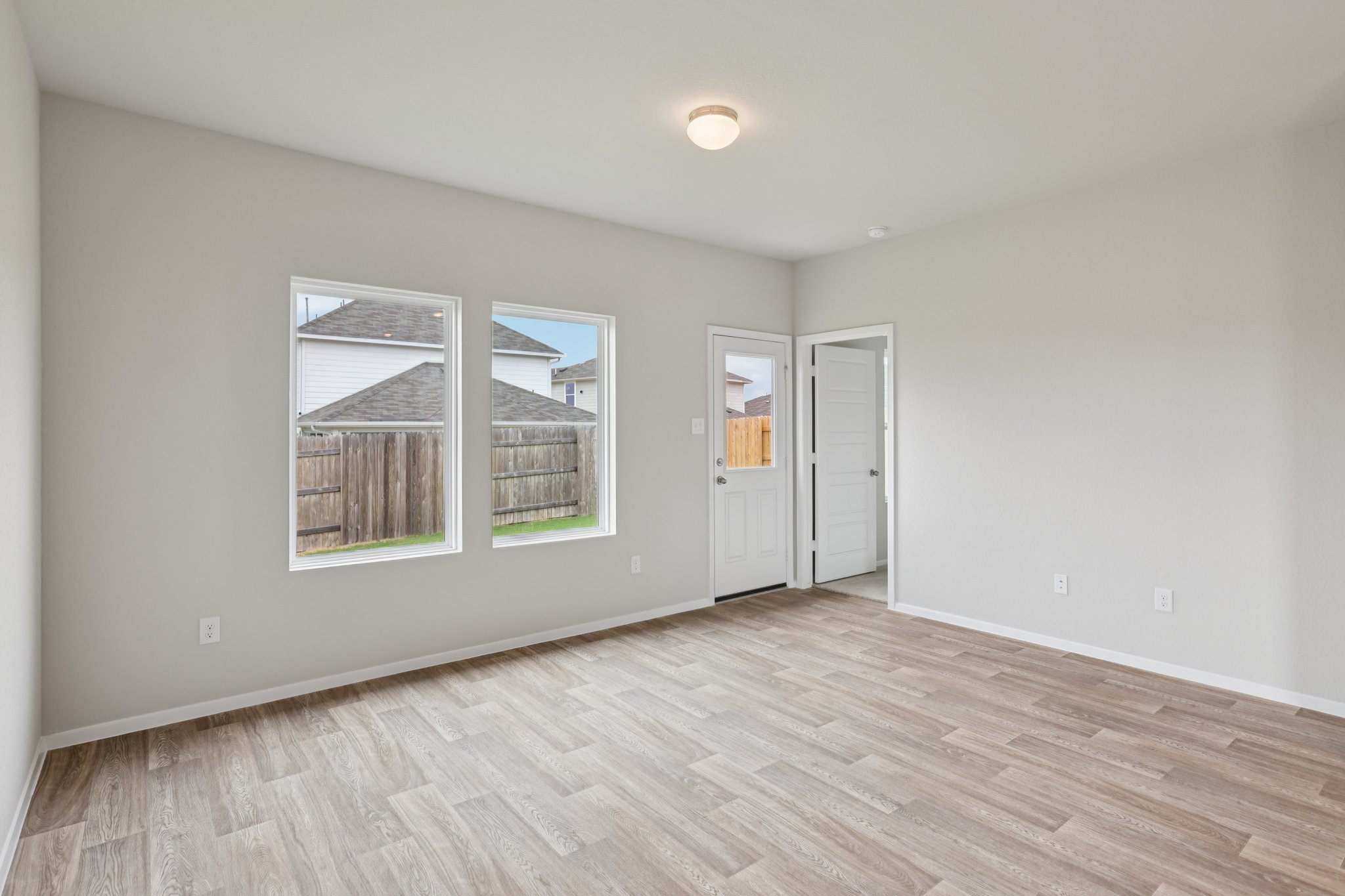 127 Tempest Trail Maxwell, TX 78656 - Photo 9 of 29 an empty room with wooden floor and windows