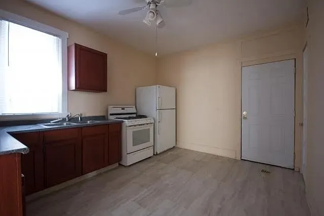 a kitchen with stainless steel appliances granite countertop a stove a sink and a refrigerator