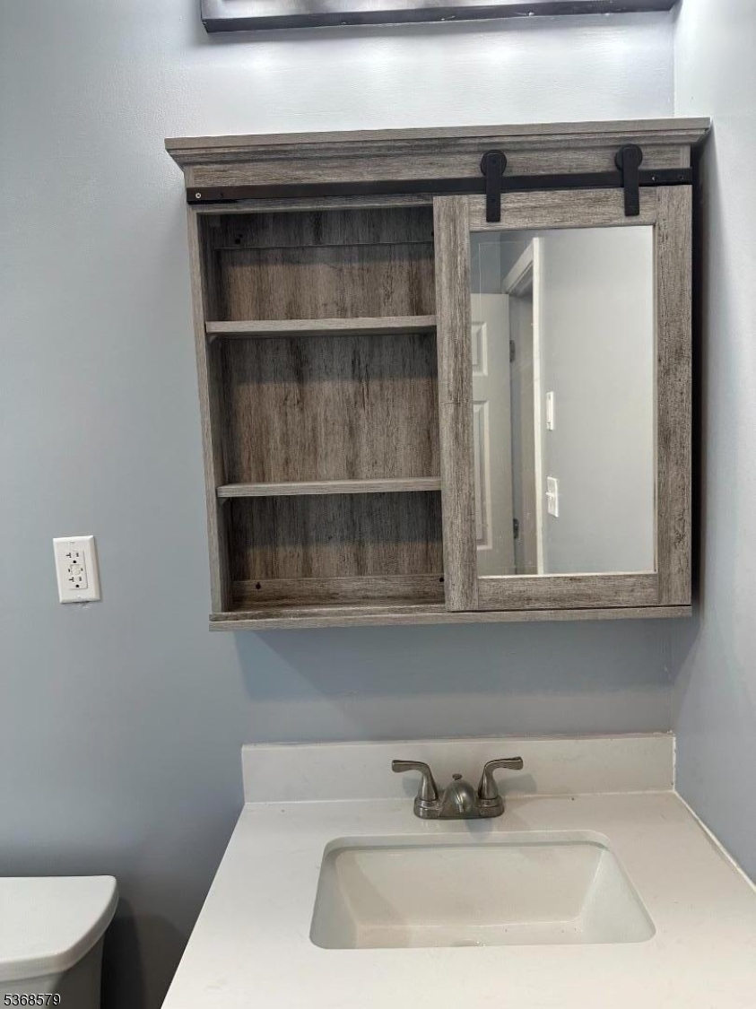 12A Gramercy Gardens Place, Unit 12 Middlesex, NJ 08846 - Photo 4 of 7 a bathroom with a sink and a toilet