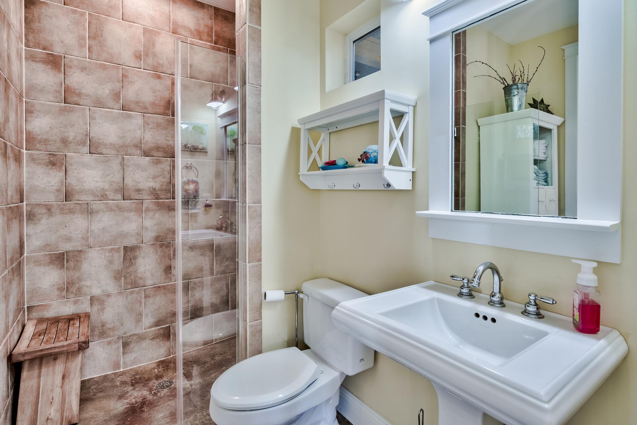 160 North Andalusia Avenue Santa Rosa Beach, FL 32459 - Photo 18 of 61 a bathroom with a sink mirror and toilet