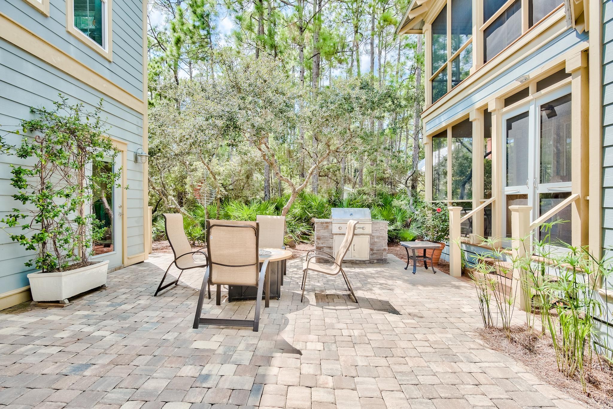 160 North Andalusia Avenue Santa Rosa Beach, FL 32459 - Photo 37 of 61 a view of a patio with a table and chairs and potted plants