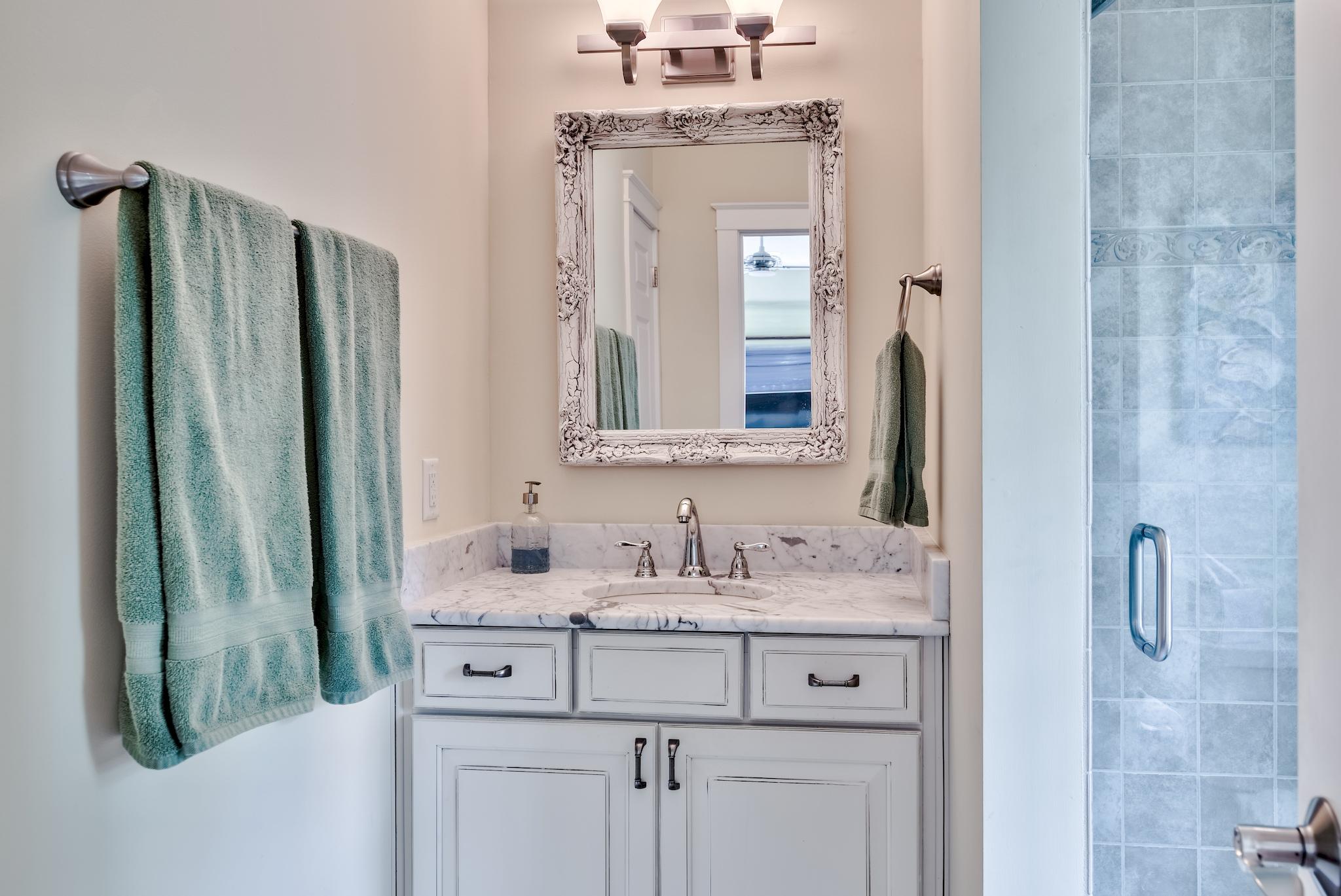 160 North Andalusia Avenue Santa Rosa Beach, FL 32459 - Photo 45 of 61 a bathroom with a sink vanity granite shower and a mirror