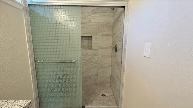 a bathroom with a shower and a sink