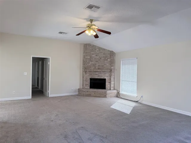 a view of an empty room with a fireplace