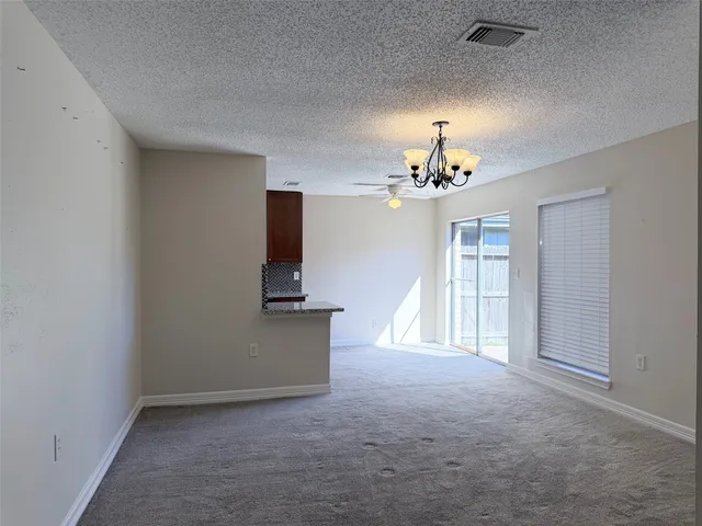 a view of a chandelier fan and entryway