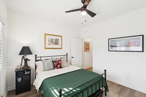 a bedroom with a bed and a lamp on table