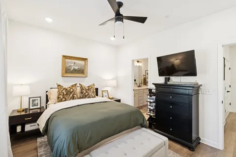 a bedroom with a bed and a flat screen tv