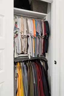 a view of walk in closet with clothes