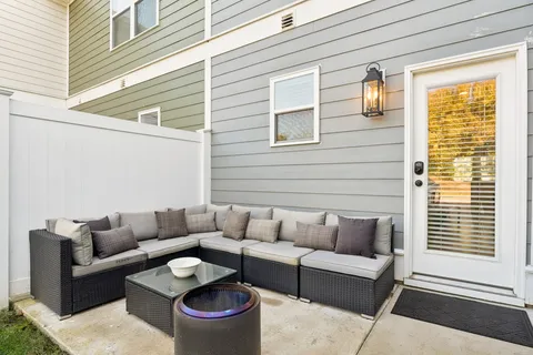 a building outdoor space with patio furniture and windows