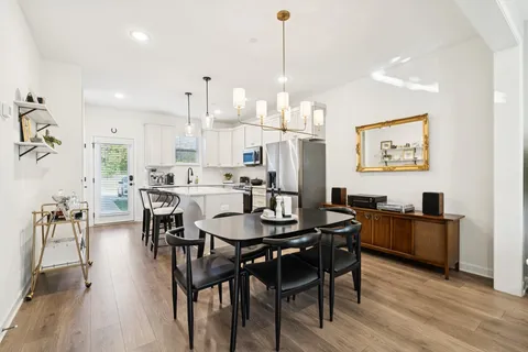 a large kitchen with a table and chairs