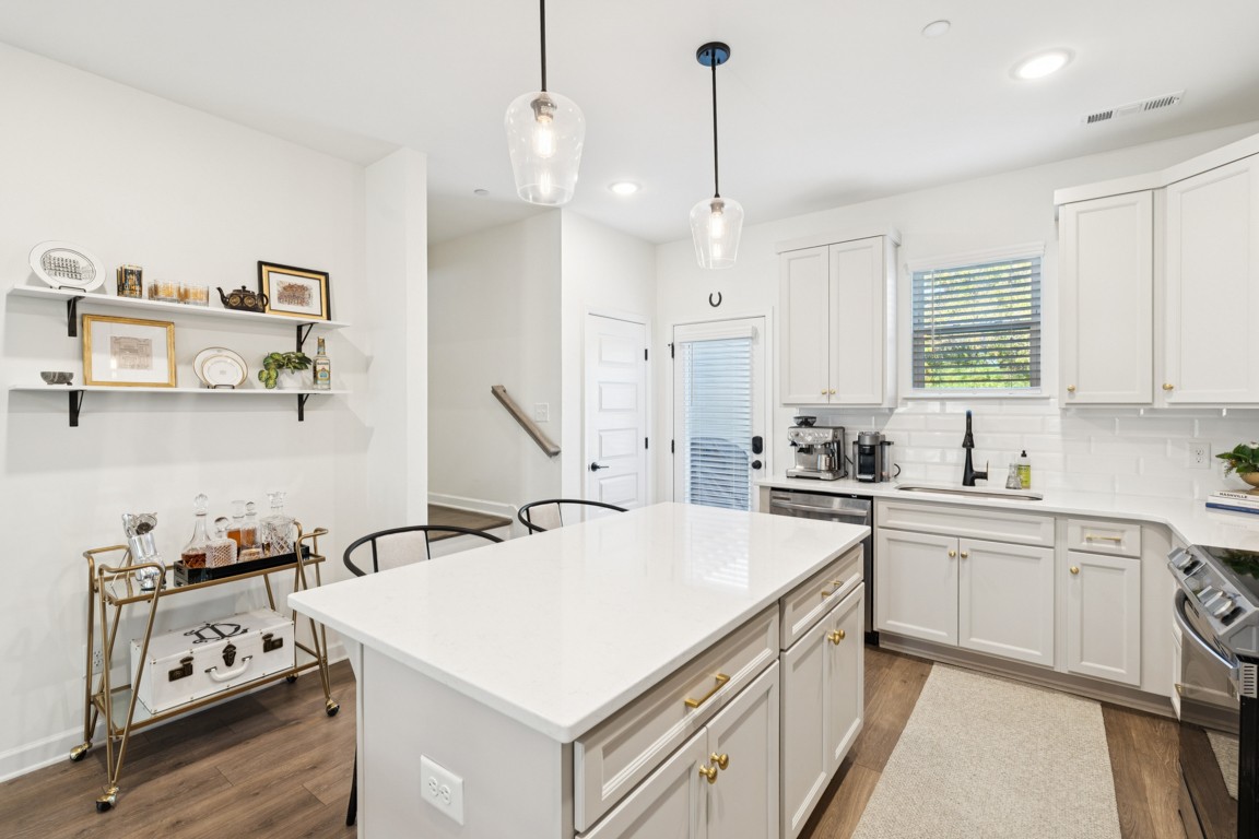 152 Bess Boulevard Spring Hill, TN 37174 - Photo 10 of 25 a kitchen that has a sink a stove and wooden floors
