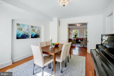 a view of a dining room with furniture a rug and wooden floor