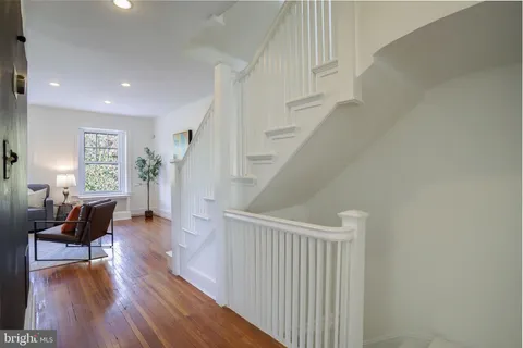 a view of a livingroom with furniture and hardwood floor