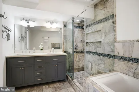 a bathroom with a bathtub and shower