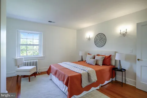 a bedroom with a bed and a table in it