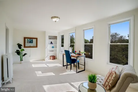 a view of an empty room with wooden stairs