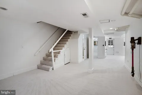 a view of an empty room with stairs