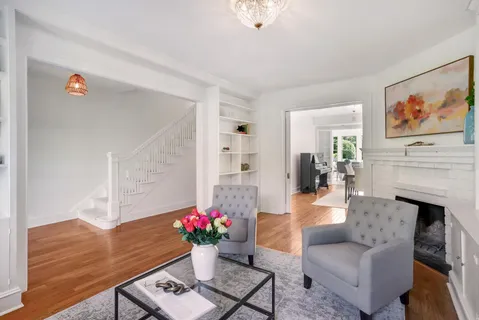 a living room with furniture potted plant and a fireplace
