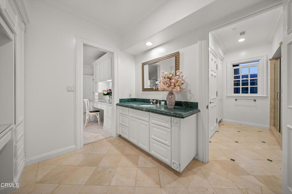 6885 Coyote Canyon Road Somis, CA 93066 - Photo 17 of 35 a kitchen with granite countertop a sink and white cabinets
