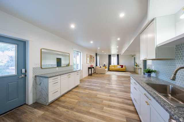 868 Braddock Lane Alpine, UT 84004 - Photo 45 of 64 Expansive interior featuring wood-finish flooring, recessed lighting, and a kitchen area with white cabinetry and a stainless steel sink