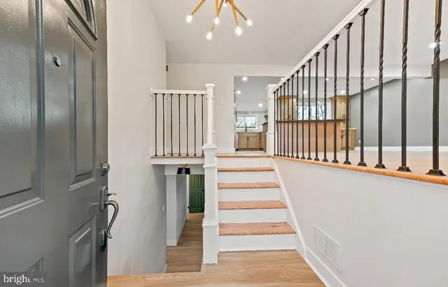 a view of entryway with wooden floor and stairs