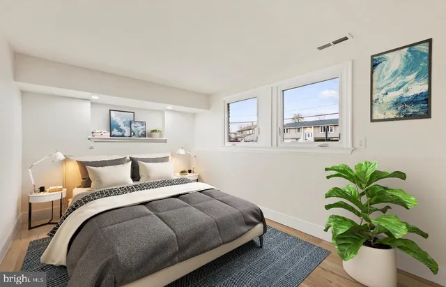 a bedroom with a bed and a painting on the wall