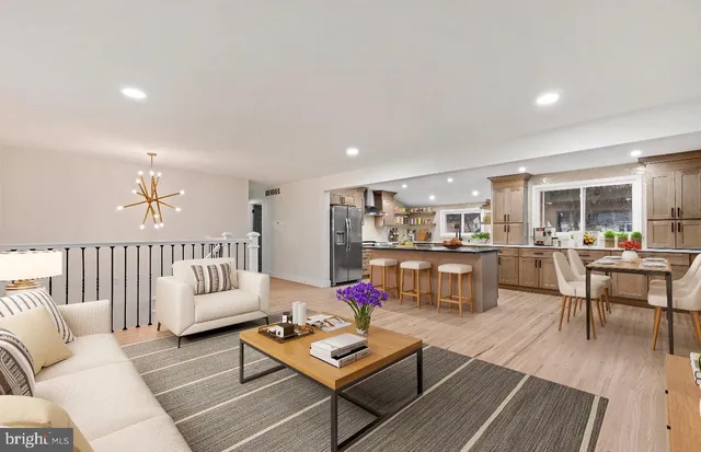 a living room with furniture and kitchen view