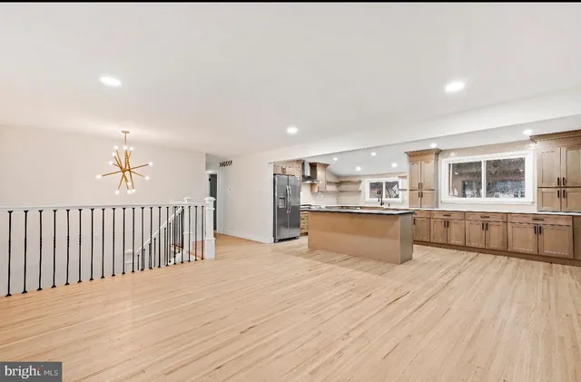 a view of kitchen with wooden floor and electronic appliances
