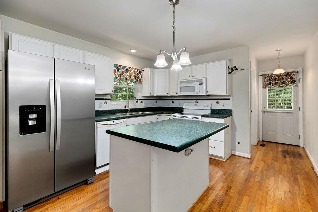 661 Jefferson Drive Palmyra, VA 22963 - Photo 16 of 41 a kitchen with stainless steel appliances granite countertop a sink a refrigerator and a wooden floor